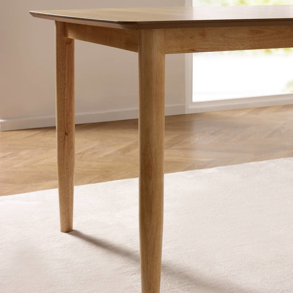 Wooden dining table with a neutral background