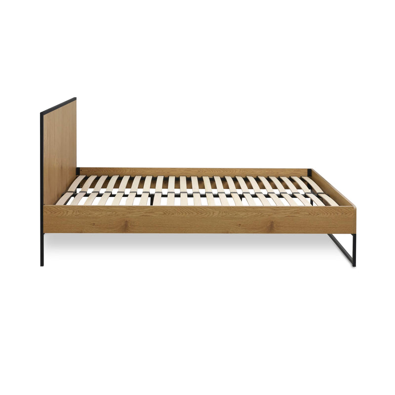 Wooden bed frame with metal legs on a white background