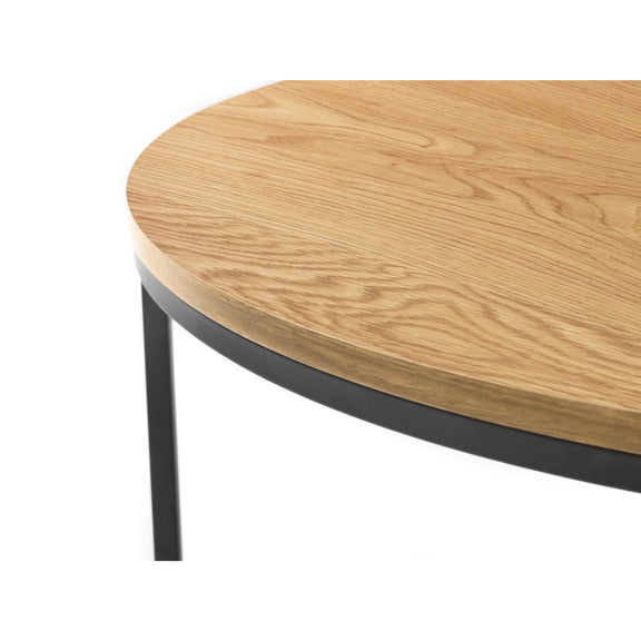 Round wooden table with a black metal base on a white background