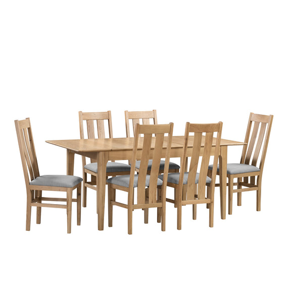 Wooden dining table with six matching chairs on a white background