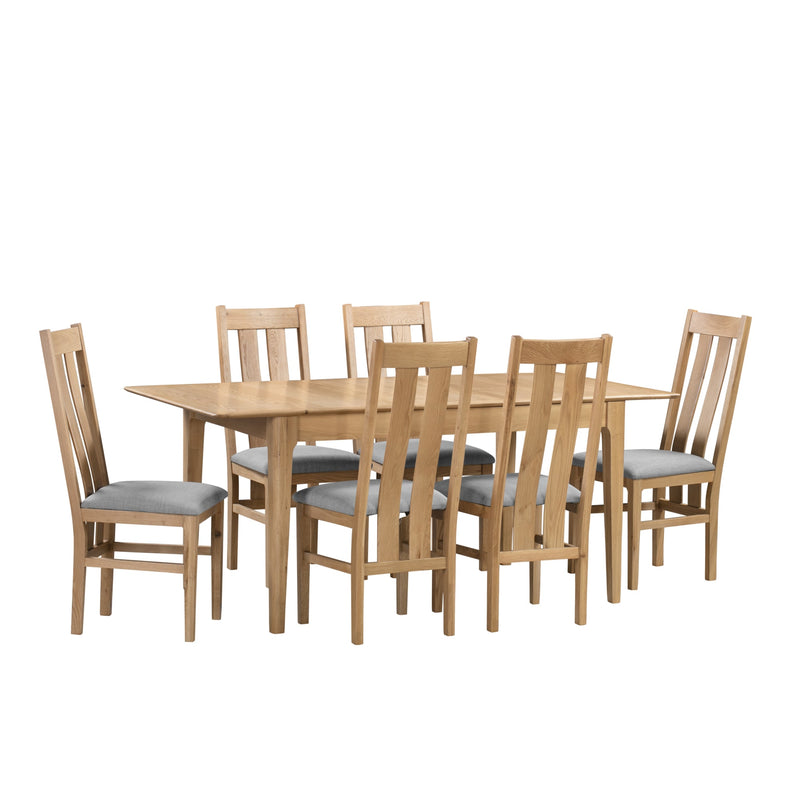 Wooden dining table with six matching chairs on a white background