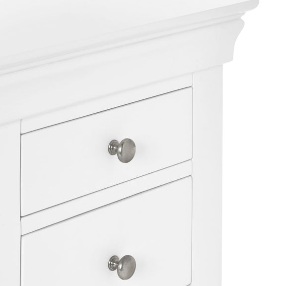 Close-up of a white cabinet with silver knobs on a white background