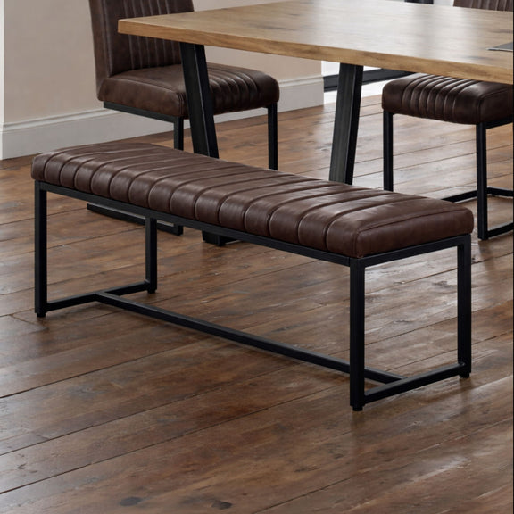 Brown leather bench with black metal frame on a wooden floor