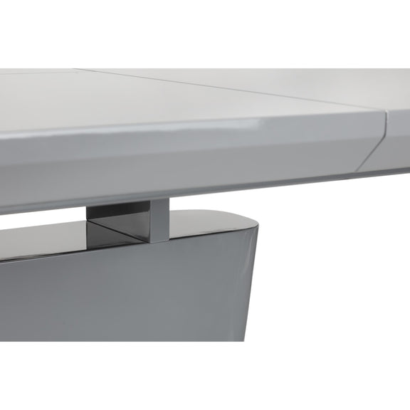 Close-up of a modern desk with a white top and metallic base.