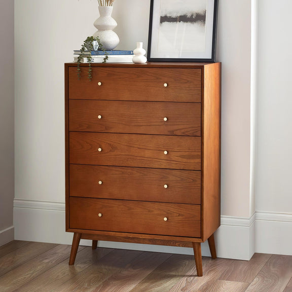 Wooden dresser with four drawers in a room setting.