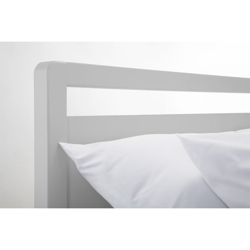 Gray metal bed frame with white bedding on a white background