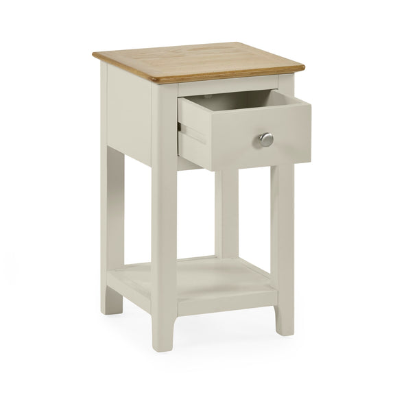 White bedside table with drawer pulled out showing storage space