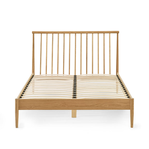 Wooden bed frame with metal headboard on a white background