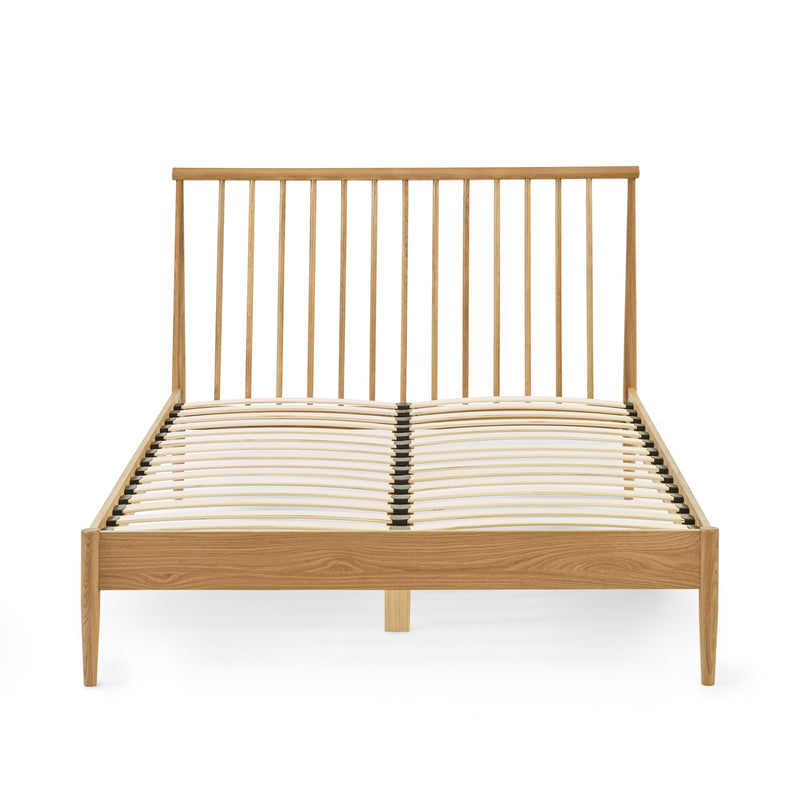 Wooden bed frame with metal headboard on a white background