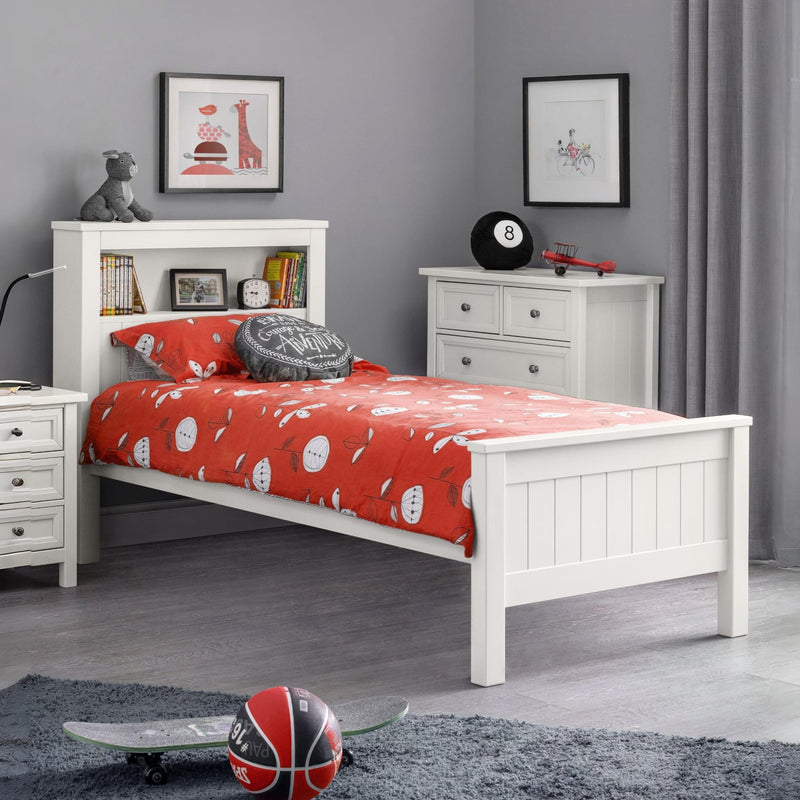 Children's bedroom with white bed, red bedding, and gray walls.