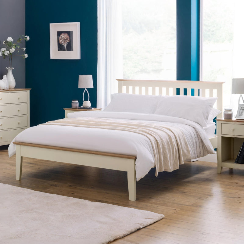 Neatly made bed in a bedroom with wooden furniture and decor.