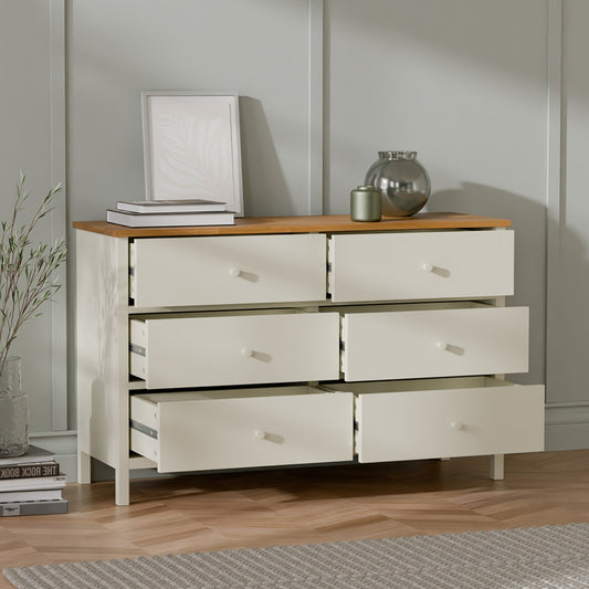 Wooden dresser with four drawers in a room setting