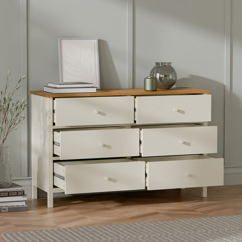 Wooden dresser with four drawers in a room setting
