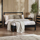 Bedroom with a black bed frame, white bedding, and decorative pillows.