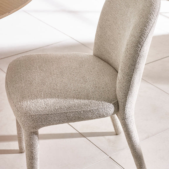 Beige textured chair on a light wooden floor