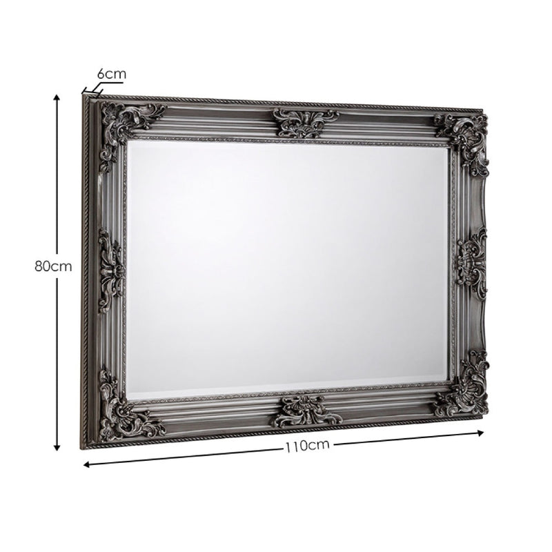 Decorative mirror with ornate frame and dimensions on a white background
