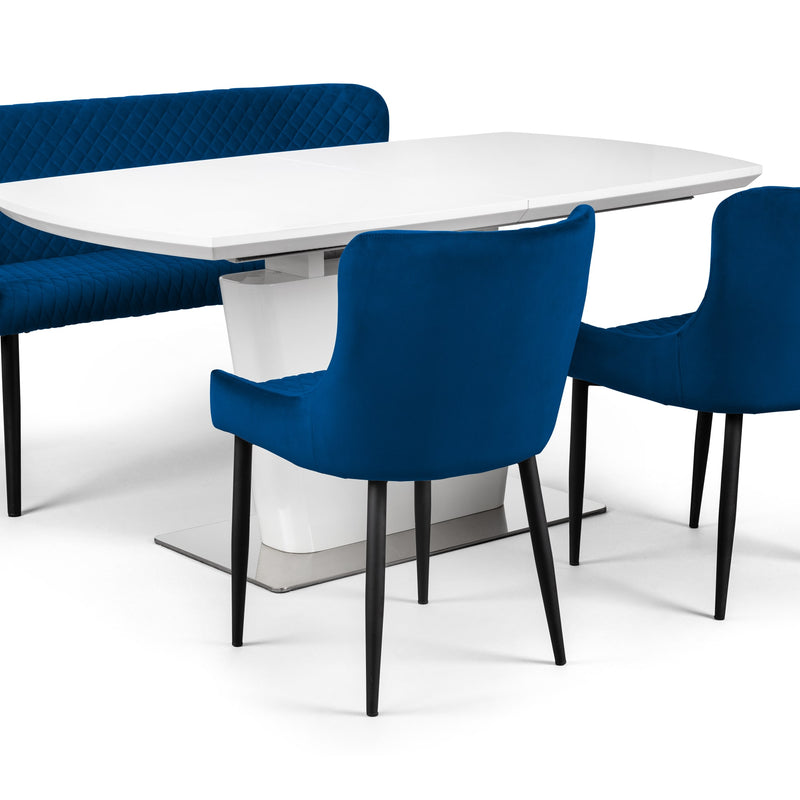 White dining table with blue chairs on a white background