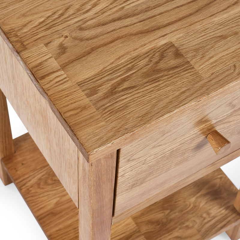 Close-up of a wooden side table with a drawer.