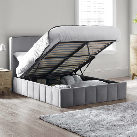 Gray upholstered bed with storage compartment in a bedroom setting