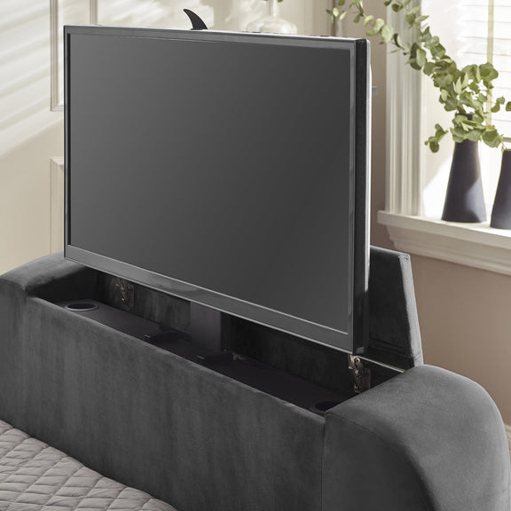 TV mounted on a headboard with cup holders in a bedroom setting