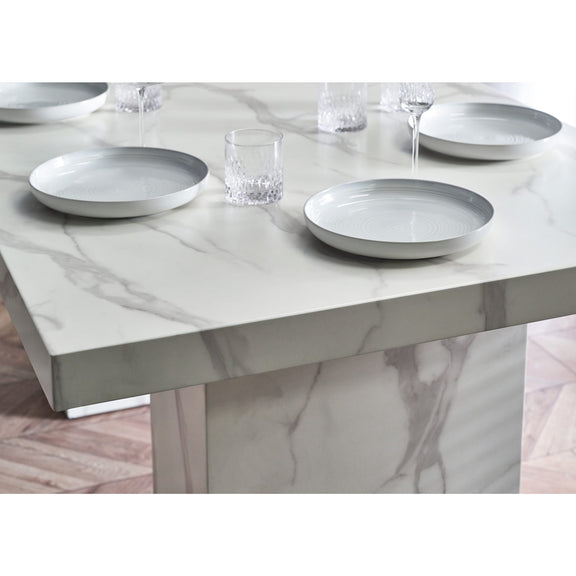 Marble-patterned dining table with plates and glasses on a white background