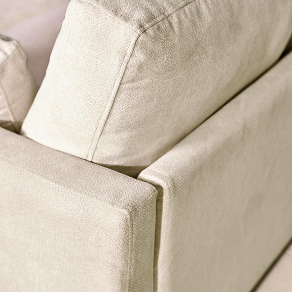 Close-up of a beige fabric sofa with a soft texture.