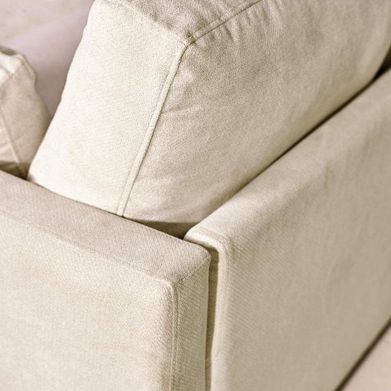 Close-up of a beige fabric sofa with a soft texture.