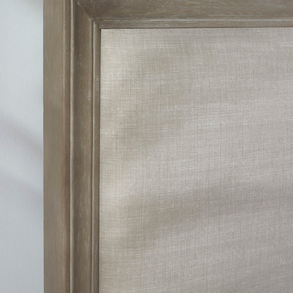 Close-up of a textured gray fabric with a wooden frame.