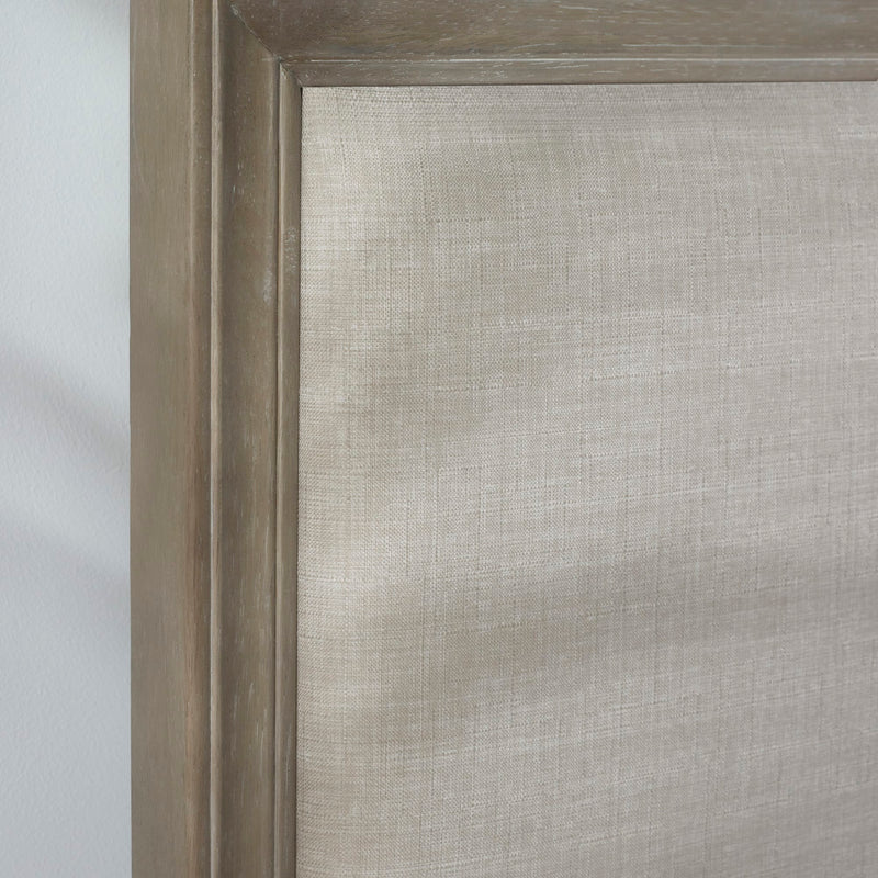 Close-up of a textured gray fabric with a wooden frame.