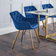 Blue chairs with gold legs around a glass dining table in a modern interior setting.