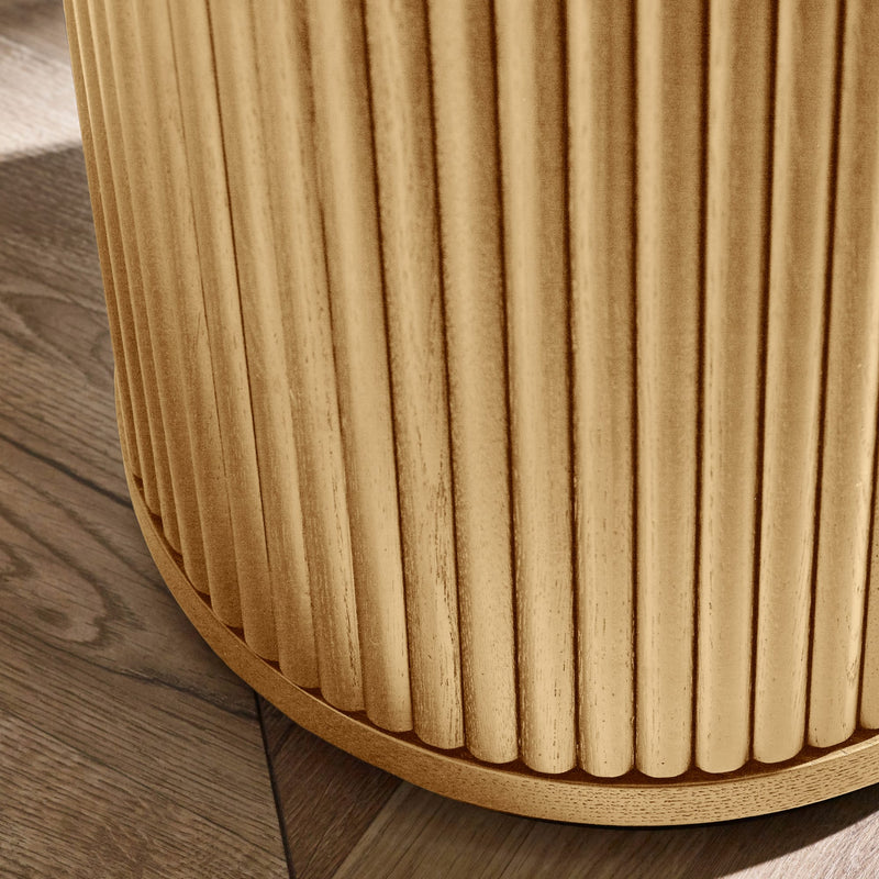 Close-up of a wooden stool with a ribbed texture on a wooden floor.