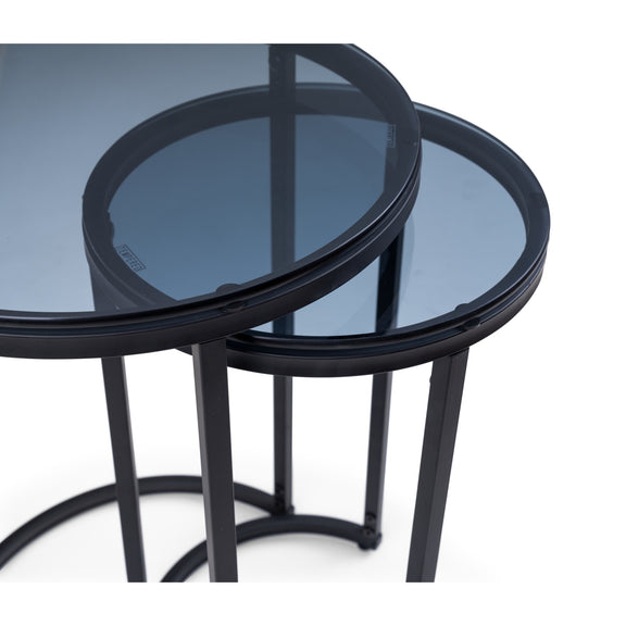 Two black glass tables stacked on a white background