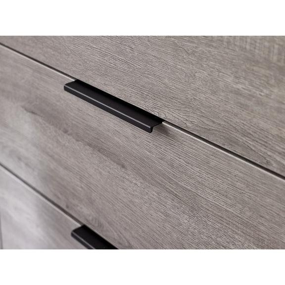Close-up of a wooden drawer with a black handle on a white background