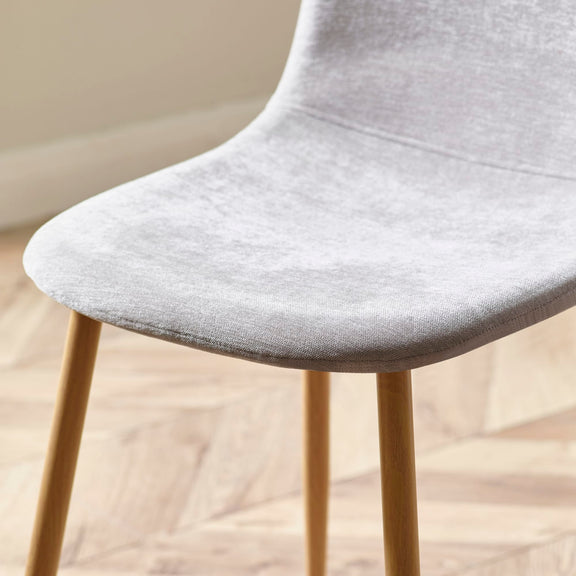 Gray chair with wooden legs on a blurred background