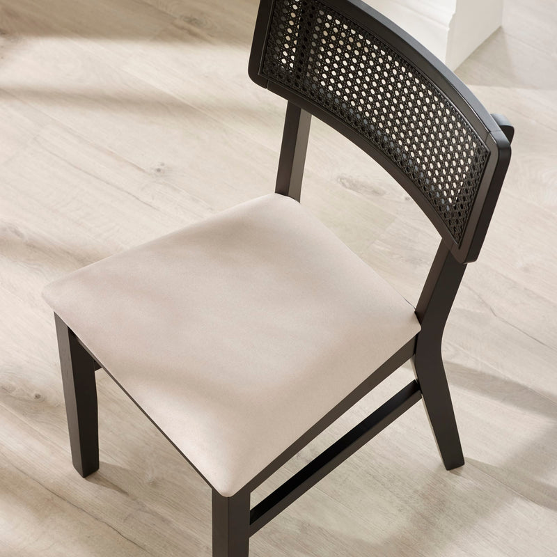 Chair with black woven backrest and beige seat on a light wooden floor