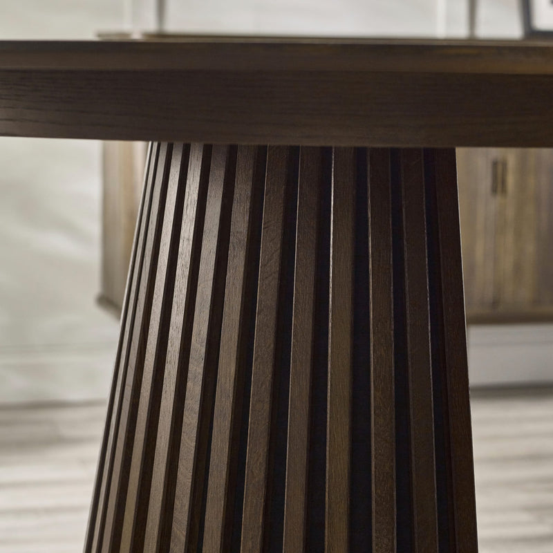 Close-up of a wooden table leg with a blurred background