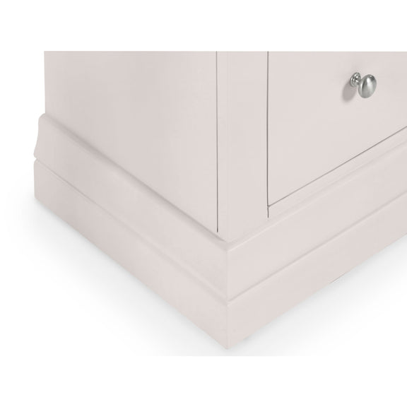 Folded light pink bed sheets on a white background