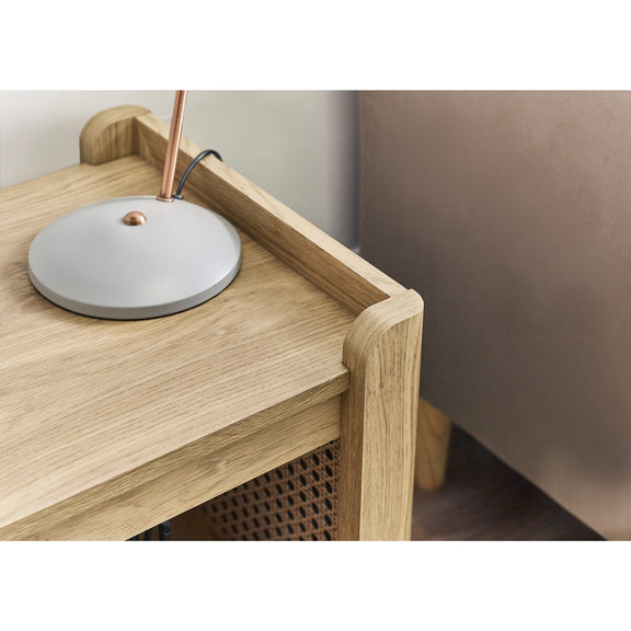 Modern lamp with a round base on a wooden surface