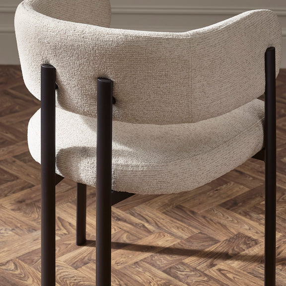 Chair with beige fabric seat and backrest on a wooden floor
