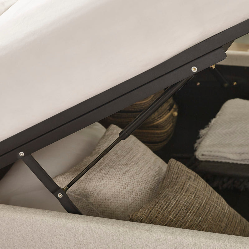 Close-up of a car seat with a black metal frame and gray cushion.
