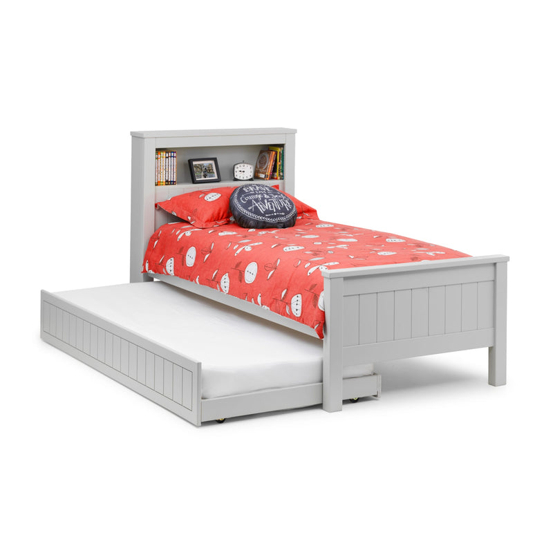 White bed with red bedding and a gray pillow on a white background