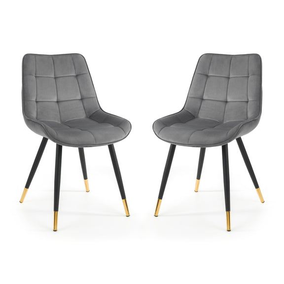 Two gray upholstered chairs with black legs and gold foot caps on a white background