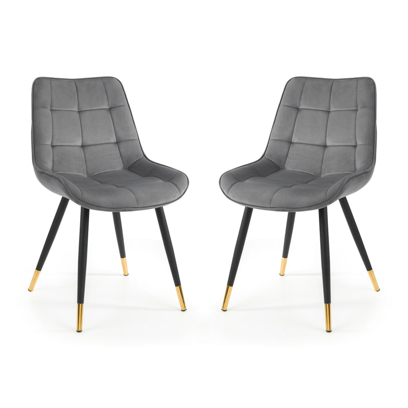 Two gray upholstered chairs with black legs and gold foot caps on a white background