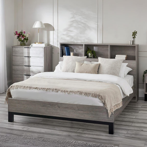 Bedroom with a wooden bed frame, white bedding, and a nightstand.