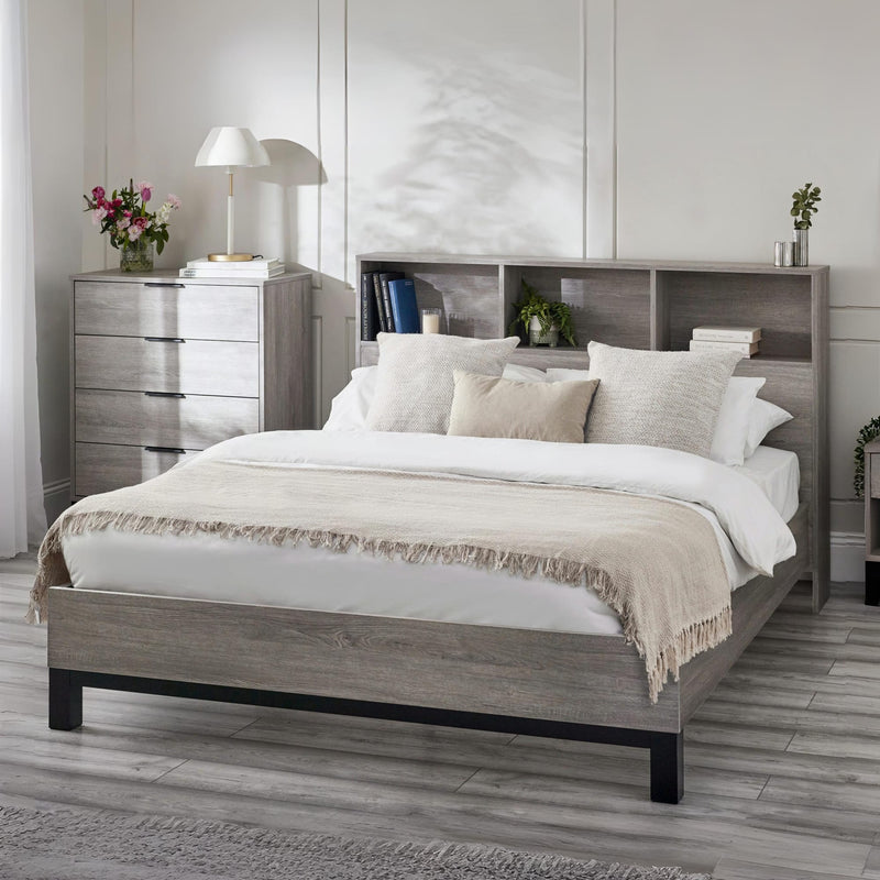 Bedroom with a wooden bed frame, white bedding, and a nightstand.