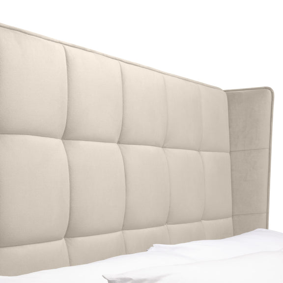 Beige quilted headboard on a white background