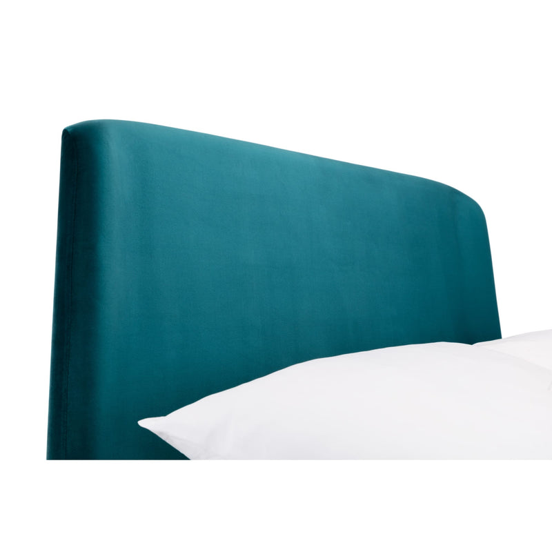 Teal upholstered headboard with a white pillow on a white background