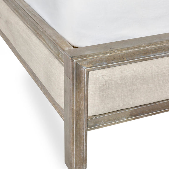 Close-up of a wooden bed frame with a textured finish on a white background