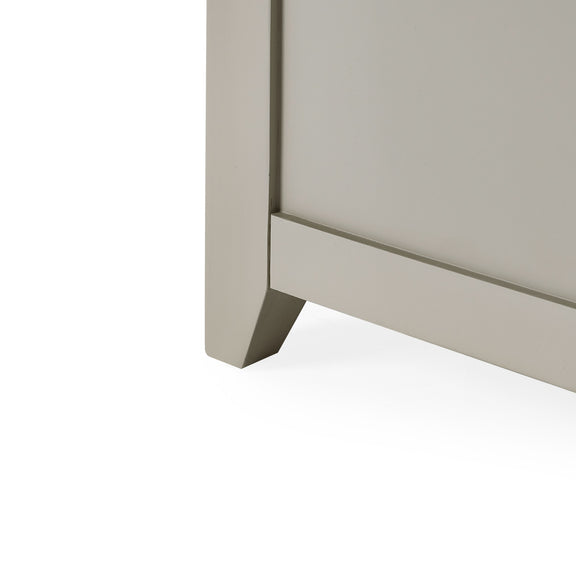 Close-up of a corner of a light gray cabinet on a white background
