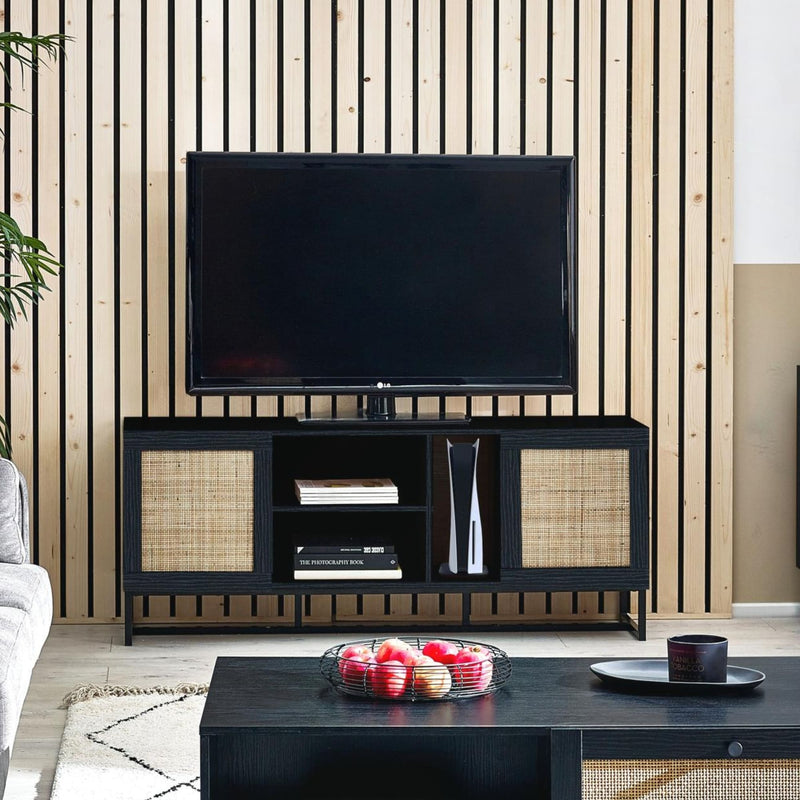 Modern living room with a black TV stand, television, and decorative items.
